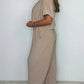 V-ringad enfärgad jumpsuit med lös midja för kvinnor