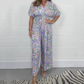 Elegant V-ringad jumpsuit med tryck och vida ben för kvinnor