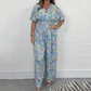 Elegant V-ringad jumpsuit med tryck och vida ben för kvinnor