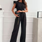 Ärmlös jumpsuit med hög midja och bälte