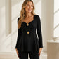 Damtopp med V-ringning och peplum med blommotiv