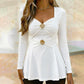 Damtopp med V-ringning och peplum med blommotiv